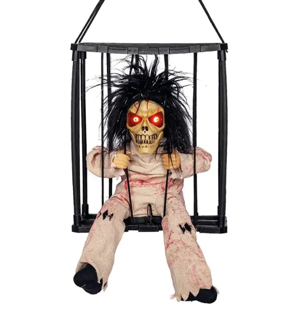 Horror-themed doll in a black cage with glowing red eyes on a white background